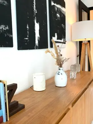 a desk with a lamp and a vase on it at Aesthetic Villa Central Canggu With an Office in Canggu