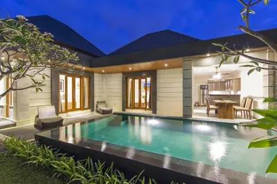 a swimming pool in the backyard of a house at The Banyumas Suite Villa Legian in Legian