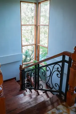 a staircase with a black railing in front of a window at Villa with private pool and garden in Nusa Dua 3BR in Nusa Dua