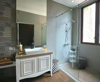 a bathroom with a white sink and a shower at Villa Maisha by REJA Villas in Nusa Dua