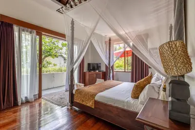 a bedroom with a bed with a canopy at Luxury 3-Bedroom Villa With Private Pool Seminyak Village in Seminyak
