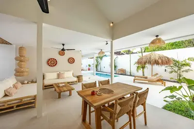 a living room with a table and a couch at Casa Kokoon - NEW Bright & Quiet 2BR Mertanadi Seminyak with Private Pool and Parking in Seminyak