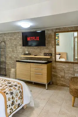 a bed room with a sqor sign on a wall at Villa Nari - GG100X Seminyak, Bali in Seminyak