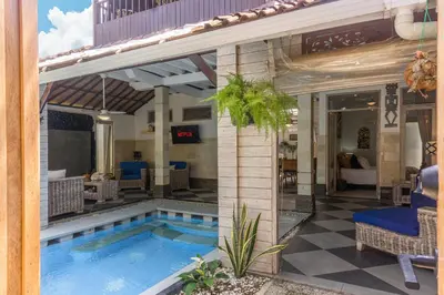 a swimming pool in the middle of a house at Villa Nari - GG100X Seminyak, Bali in Seminyak