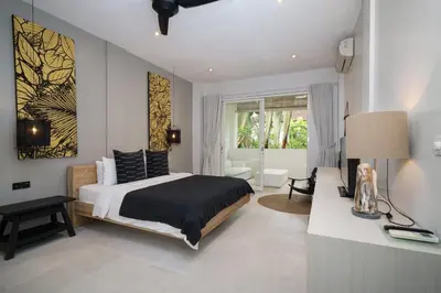 a bedroom with a king sized bed and a desk at Villa Stella Seminyak in Seminyak