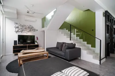 a living room with a couch and a staircase at Villa Stella Seminyak in Seminyak