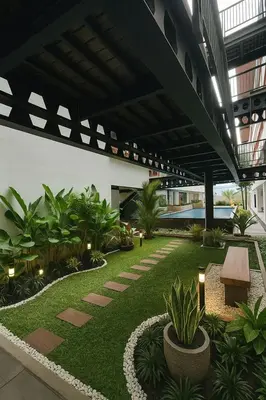 a courtyard with plants in a building at Alzeto Coliving in Legian