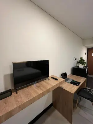 a living room with a large flat screen tv on a wall at Alzeto Coliving in Legian