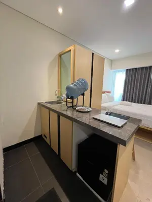 a room with a counter with a sink and a bed at Alzeto Coliving in Legian