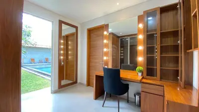 a home office with a desk and a blue chair at YY Villa Seminyak - 4BR Luxury Private Villa in Seminyak
