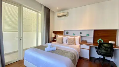 a bedroom with a bed and a desk and a computer at YY Villa Seminyak - 4BR Luxury Private Villa in Seminyak