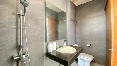 a bathroom with a sink and a shower with a toilet at YY Villa Seminyak - 4BR Luxury Private Villa in Seminyak