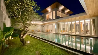 a house with a swimming pool in front of it at YY Villa Seminyak - 4BR Luxury Private Villa in Seminyak
