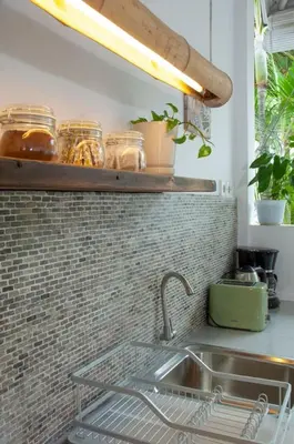 a kitchen with a sink and a shelf with jars at FANTASTIC 1 BR VILLA PRIVATE POOL WALK TO BEACH in Badung