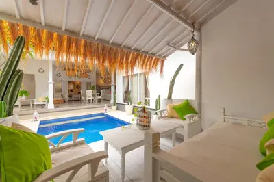 a villa with a swimming pool and a living room at Smile - One Bedroom Villa in the Seminyak center in Seminyak