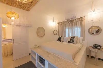 a bedroom with a large bed and a window at Smile - One Bedroom Villa in the Seminyak center in Seminyak