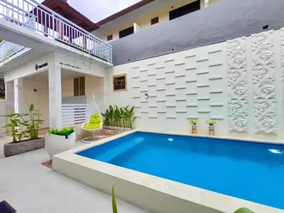 a swimming pool in the backyard of a house at Thapleuk Residence in Nusa Dua