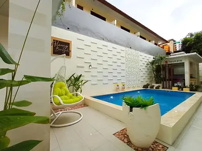 a pool in the middle of a building with plants at Thapleuk Residence in Nusa Dua