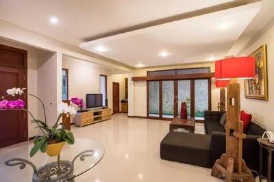 a living room with a couch and a table at Villa Tantri in Kerobokan