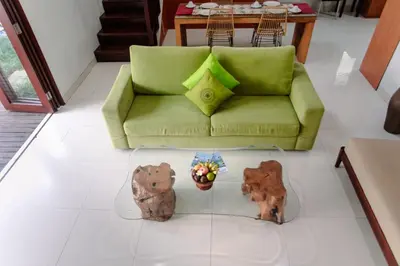 a living room with a couch and two figurines of bears at Bali mansion kuta in Legian