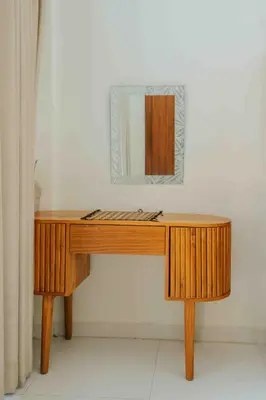 a wooden desk with a mirror on a wall at Shantia Villa 10 minutes walk to Double Six Beach Seminyak in Seminyak
