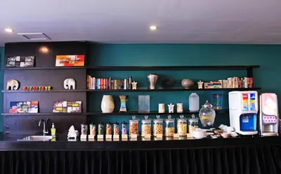 a bar with bottles of alcohol on a shelf at Watermark Hotel & Spa Bali in Jimbaran