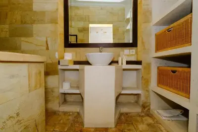 a bathroom with a sink and a mirror at Villa Jepun Seminyak in Canggu