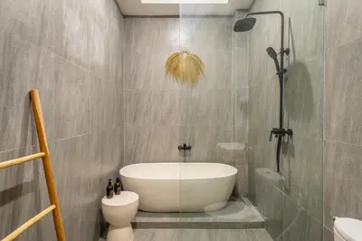 a bathroom with a bath tub and a toilet at Balibay 3 - Luxurious Private Villa with Pool, Just Minutes from the City Center! in Seminyak