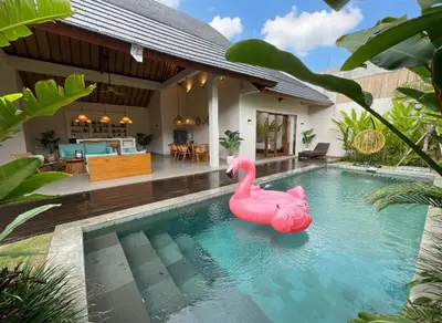 a pink rubber duck in a swimming pool in front of a house at Villa Sinergi Seminyak 6 in Seminyak