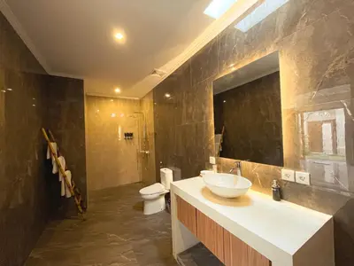 a bathroom with a sink and a toilet at Villa Sinergi Seminyak 6 in Seminyak