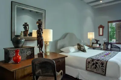 a bedroom with a bed and a desk with a mirror at Room & Vespa 3 - Relaxing Stay Center Seminyak in Seminyak