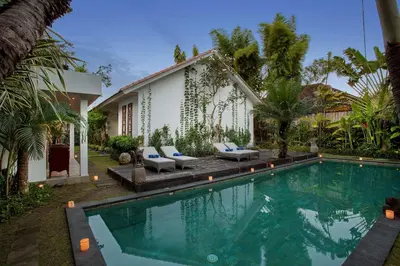 a swimming pool in front of a house at Room & Vespa 3 - Relaxing Stay Center Seminyak in Seminyak