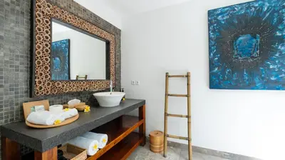 a bathroom with a sink and a mirror at Villa Anjali Blue by Villa Finder in Seminyak