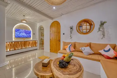a living room with a couch and a table at 3 Bed Cozy Mediterranean-Style Escape in Berawa in Canggu