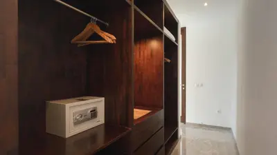 a kitchen with a microwave on a wooden wall at Villa Anjali Orange by Villa Finder in Seminyak