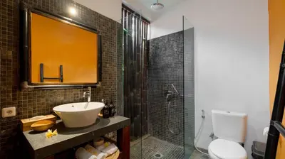a bathroom with a sink and a shower and a toilet at Villa Anjali Orange by Villa Finder in Seminyak