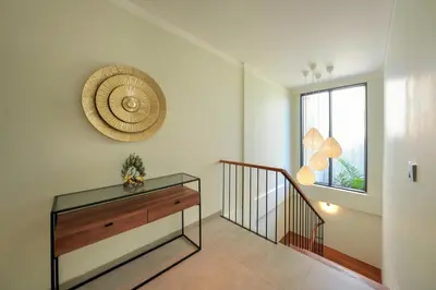 a hallway with a glass table and a window at Twin Villas Cora & Zeno by Exotic Bali Properties in Seminyak