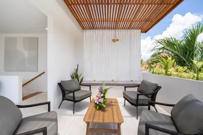 a living room with a table and chairs at Villa Mandara Double Six in Legian