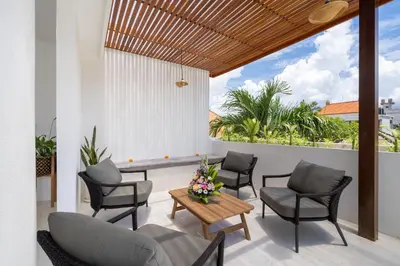 a patio with chairs and a table and a table at Villa Mandara Double Six in Legian