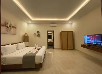 a bedroom with a bed and a flat screen tv at Villa Sinergi Seminyak 4 in Seminyak