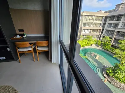 a balcony with a view of a swimming pool at de' Asasta Apartment Benoa N-511 in Nusa Dua