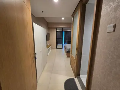a hallway of a room with a bed and a door at de Asasta Apartment Benoa E-105 in Nusa Dua