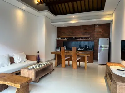 a living room with a couch and a table at Villa Lil'u in Seminyak