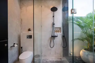 a bathroom with a glass shower with a toilet at Villa Vantage 8, Umalas in Kerobokan