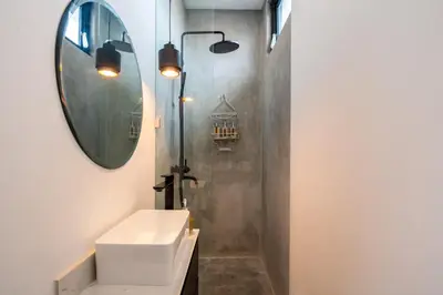 a bathroom with a sink and a mirror at Villa Vantage 8, Umalas in Kerobokan
