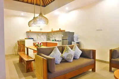 a living room with a couch and a kitchen at Villa Sinergi Seminyak 3 in Seminyak