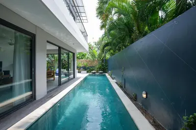 an infinity pool in the backyard of a house at Villa Cora Seminyak Walk to Double Six Beach in Seminyak