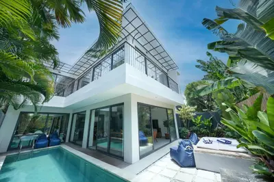 a villa with a swimming pool and a house at Villa Cora Seminyak Walk to Double Six Beach in Seminyak