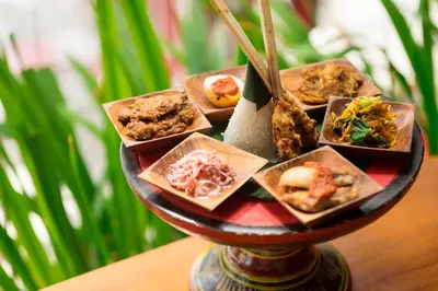 a plate of food sitting on a table at d'primahotel Petitenget Seminyak 2 in Seminyak