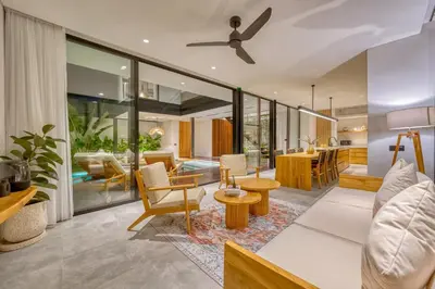 an open living room with a ceiling fan at Luxury Industrial-Style 2BR Villa Kirma Near the Beach in Canggu